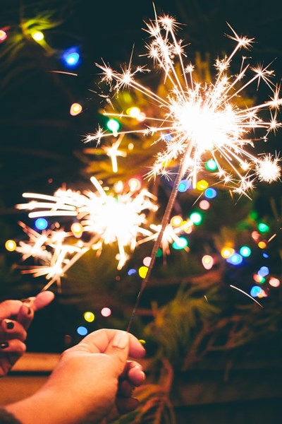 New_Years_Sparklers_with_Christmas_Lights_in_the_background